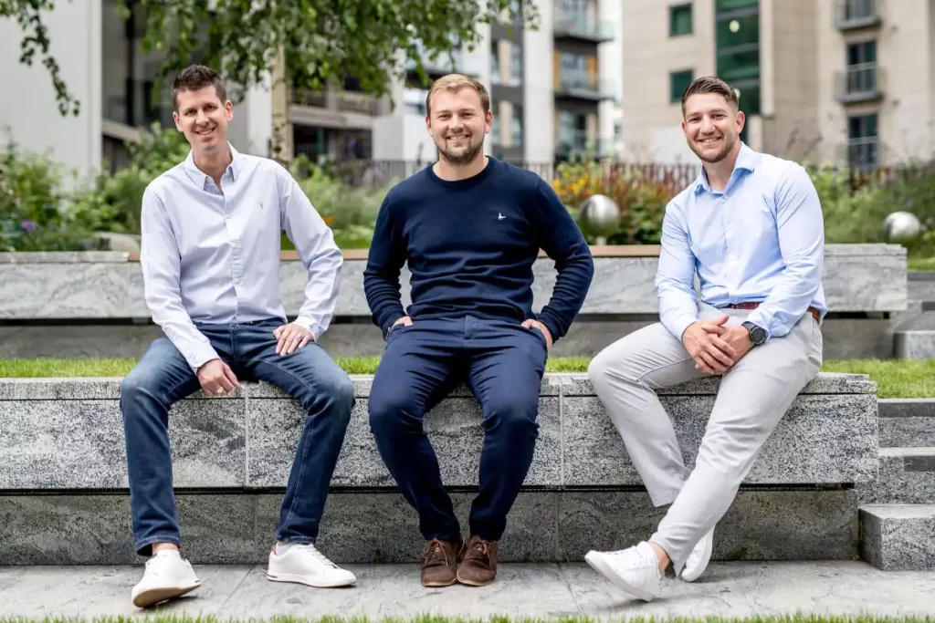 Three team members of Platform365 sitting outside looking at camera